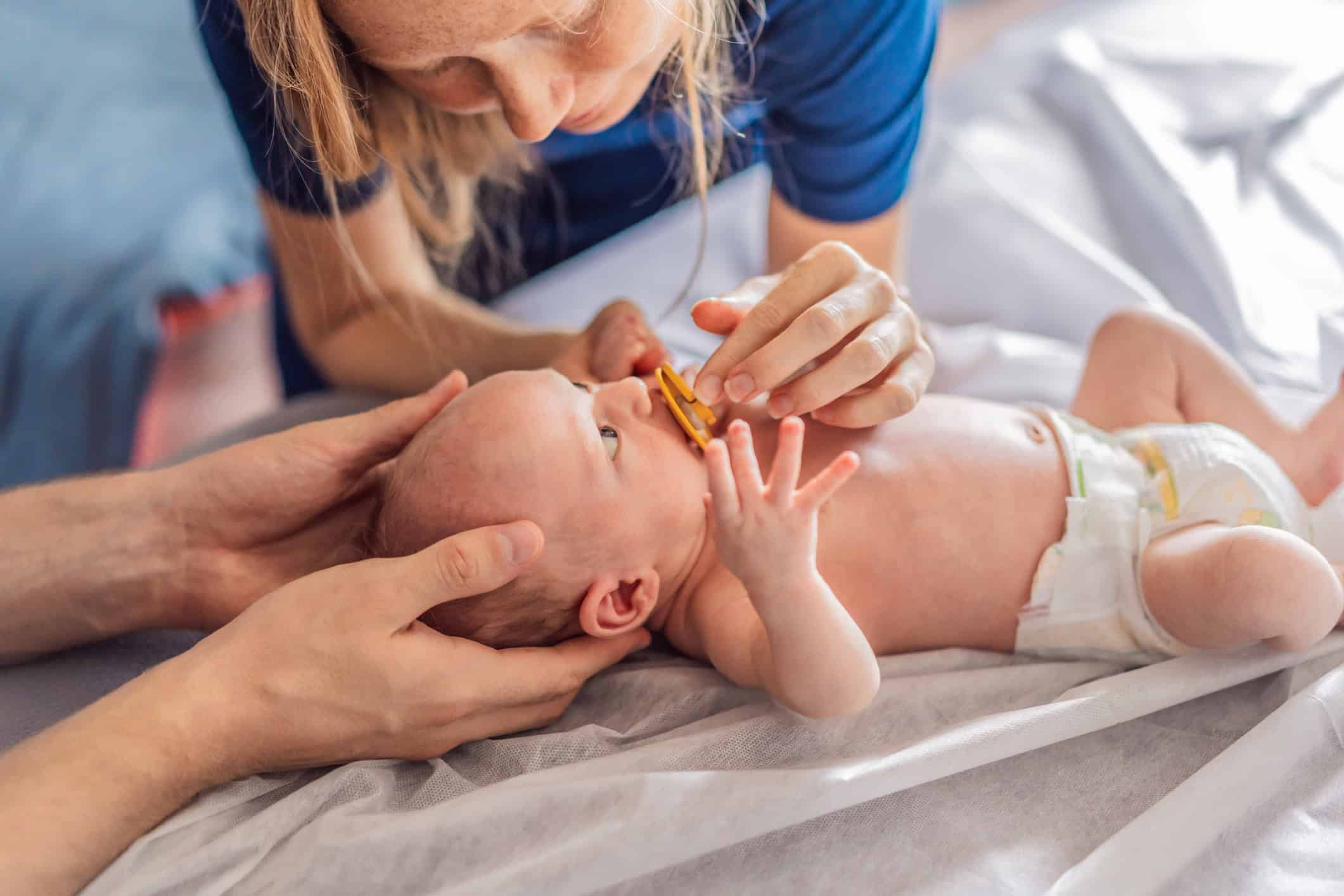 A newborn baby receives gentle osteopathic care, lying calmly while the specialist carefully examines and adjusts the infant. A moment of professional pediatric care, early development, and holistic well-being, symbolizing health and nurturing touch.